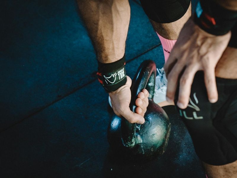 Close-up of a man gripping a weight with intense focus